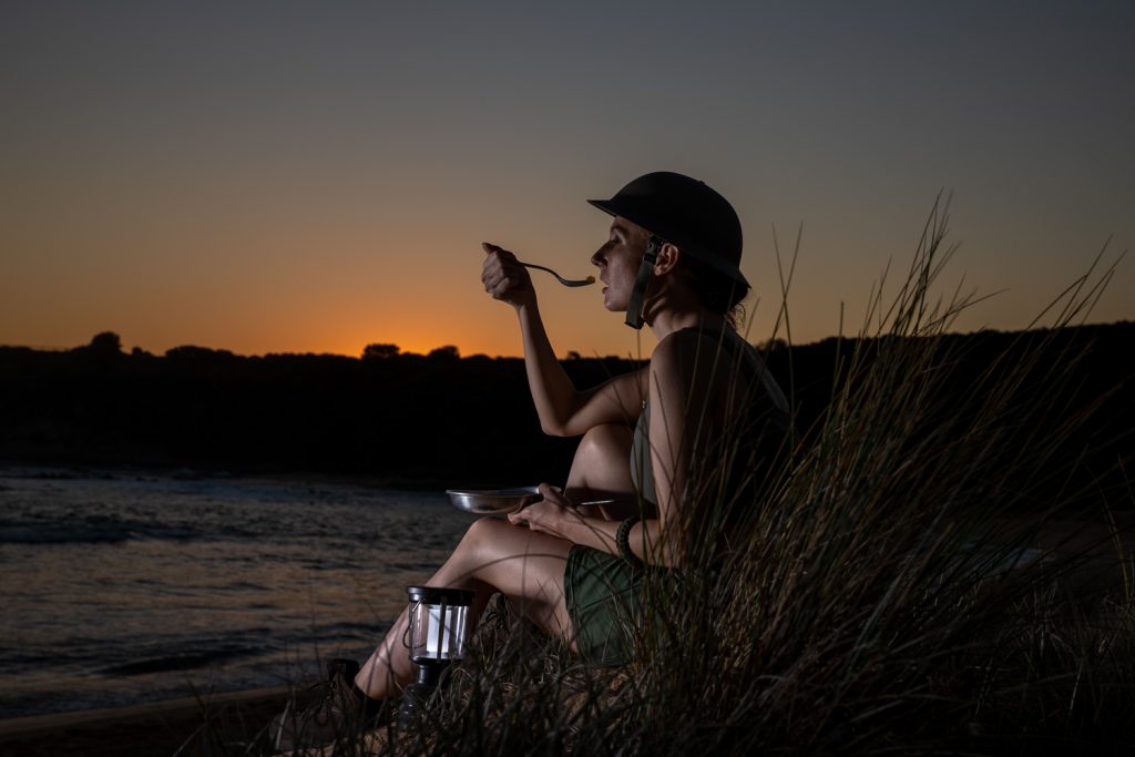 Art Project: Operation Bilby, Supper Time. Female soldier eating at sunset.