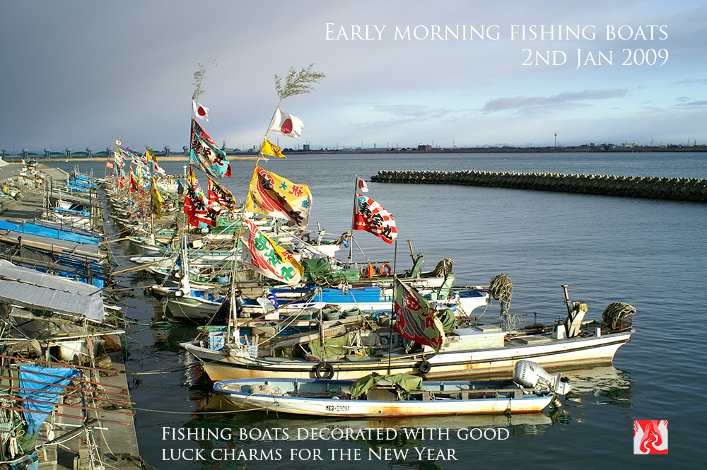 Fishing boats with Shinto good luck charms and well wishes for the new fishing year in Japan