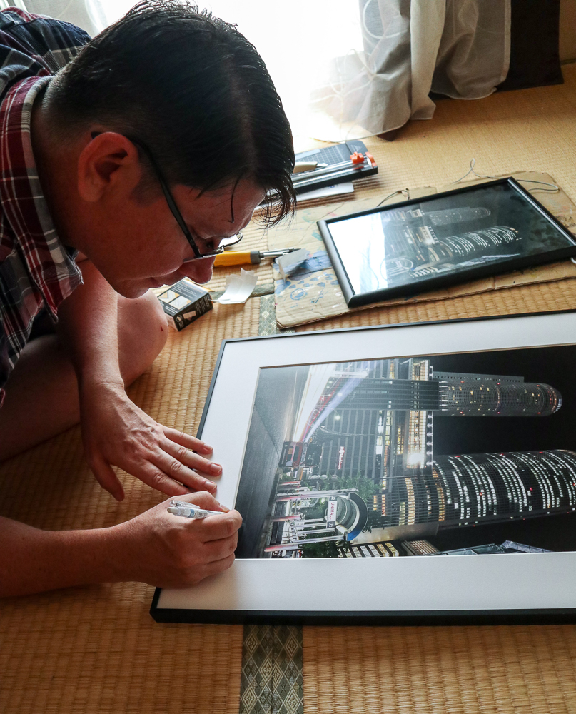 Andrew signing an art print