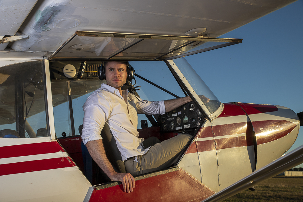 A portrait of a man in a light aircraft